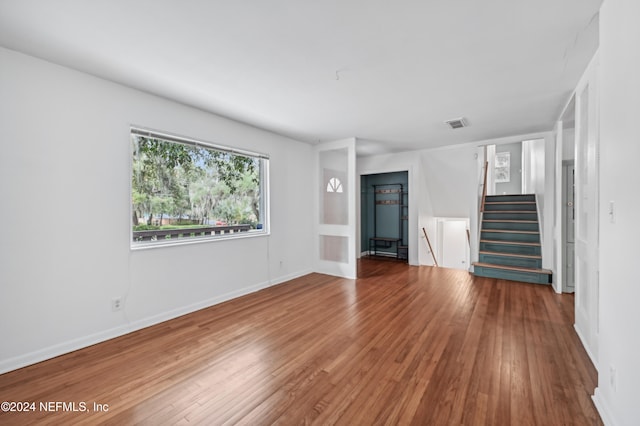 unfurnished living room with hardwood / wood-style flooring