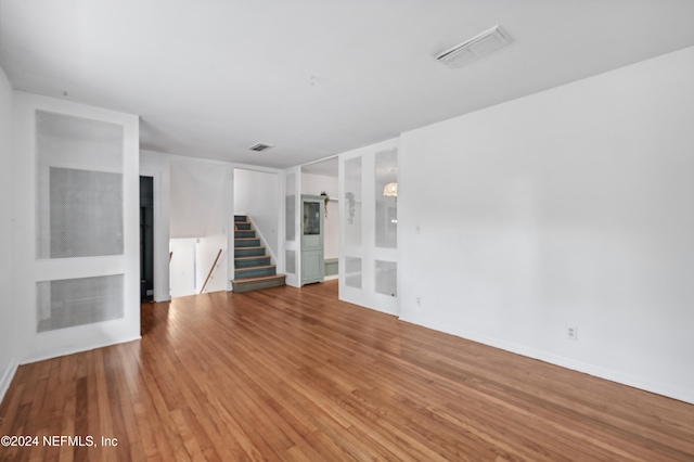 unfurnished living room with hardwood / wood-style floors