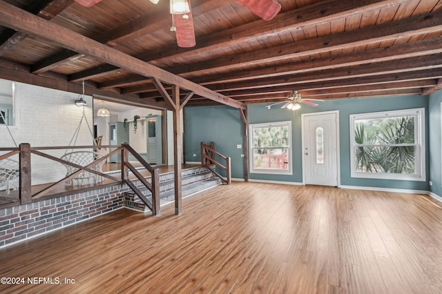 foyer entrance featuring beam ceiling, a healthy amount of sunlight, wood ceiling, and wood-type flooring