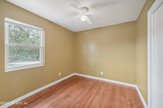 empty room with light wood-type flooring and ceiling fan