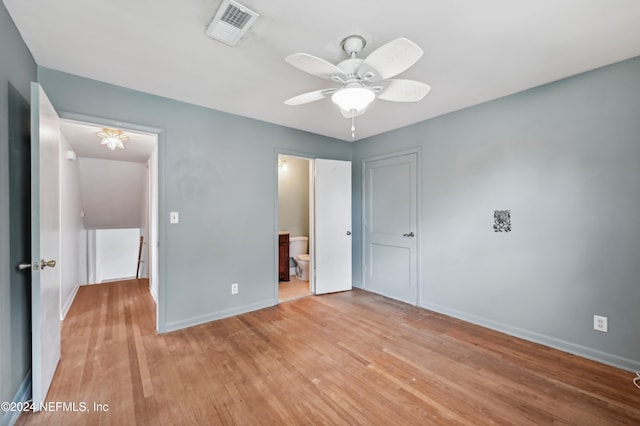 unfurnished bedroom with ceiling fan, light wood-type flooring, and connected bathroom