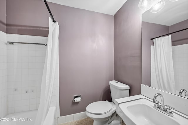 full bathroom with toilet, sink, shower / bath combo, and tile patterned flooring