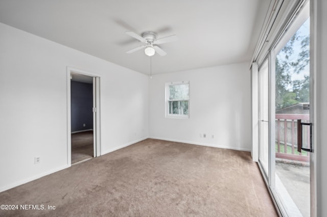 carpeted empty room featuring ceiling fan