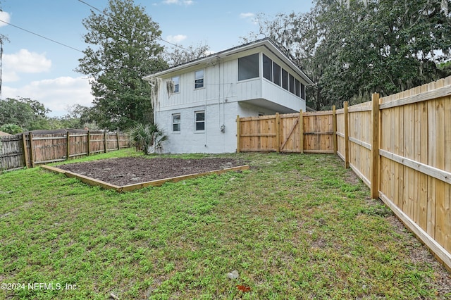 back of house featuring a lawn