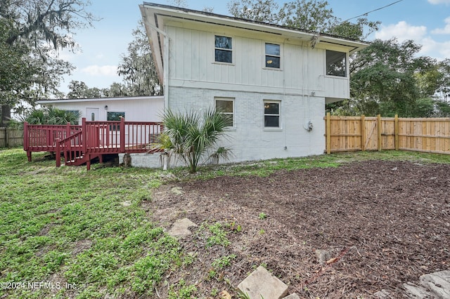 back of property featuring a deck