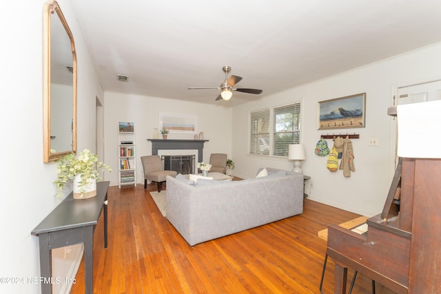 living room with ceiling fan and hardwood / wood-style flooring