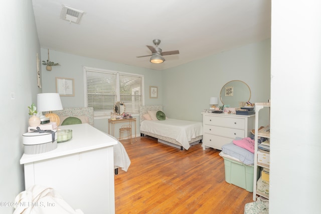 bedroom with ceiling fan and light hardwood / wood-style floors