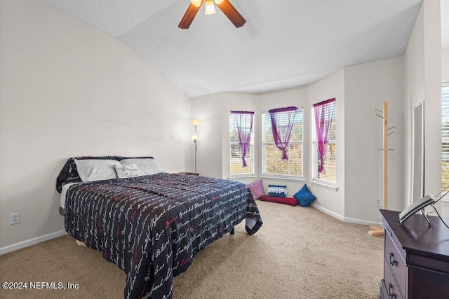 carpeted bedroom featuring ceiling fan, lofted ceiling, and a textured ceiling