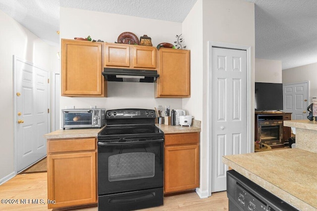 kitchen featuring dishwasher, a textured ceiling, light hardwood / wood-style flooring, and black / electric stove