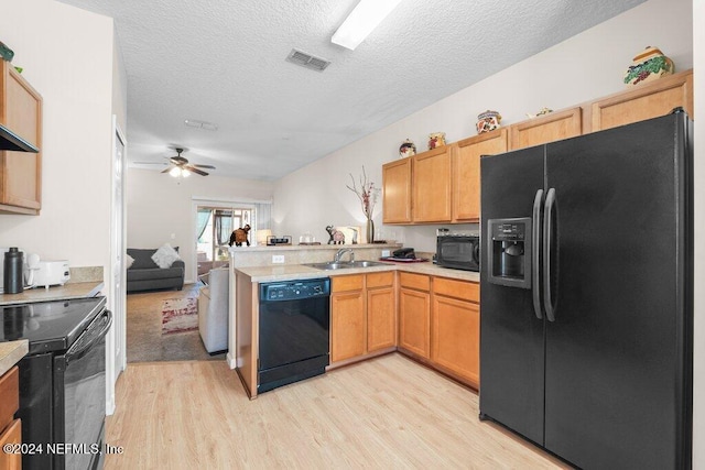 kitchen featuring ceiling fan, black appliances, a textured ceiling, and light wood-type flooring