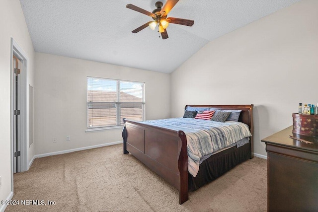 bedroom featuring a textured ceiling, ceiling fan, lofted ceiling, and light carpet