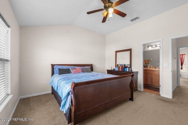 carpeted bedroom with ceiling fan, connected bathroom, and vaulted ceiling