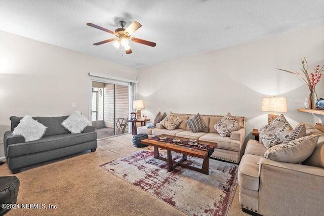 carpeted living room featuring ceiling fan and a textured ceiling