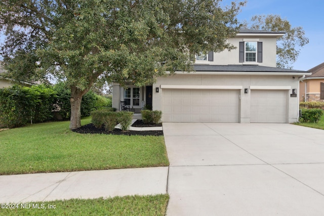 view of front of house with a garage and a front lawn