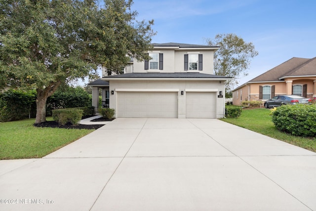 view of front facade featuring a garage and a front lawn