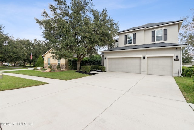 view of front facade featuring a garage and a front lawn