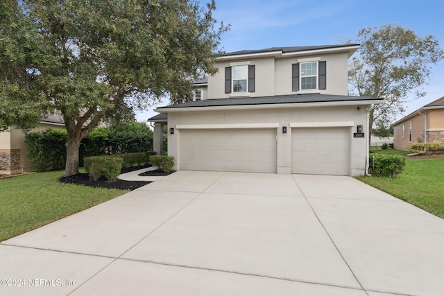 view of front facade featuring a garage and a front yard