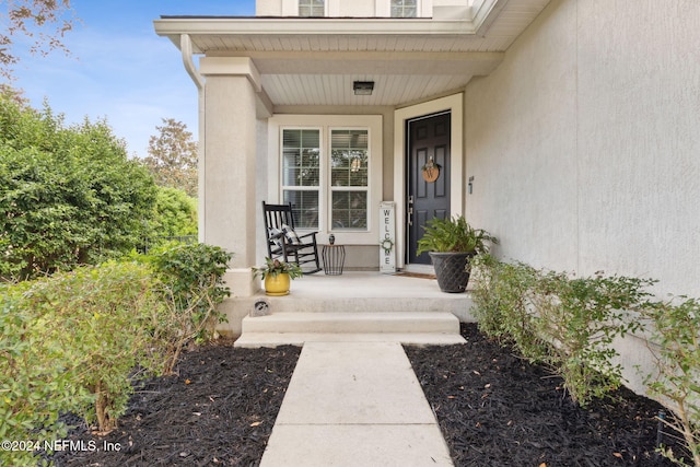 doorway to property featuring covered porch