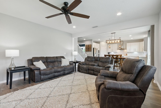 living room with ceiling fan and wood-type flooring