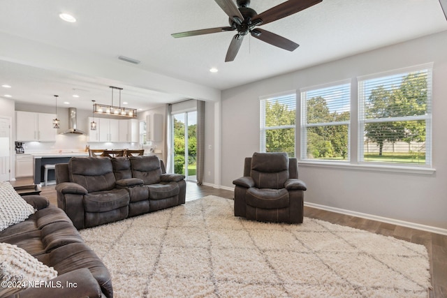 living room featuring hardwood / wood-style flooring, ceiling fan, and a healthy amount of sunlight