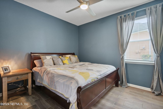 bedroom with hardwood / wood-style flooring and ceiling fan