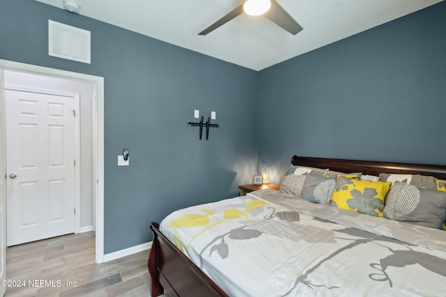 bedroom featuring hardwood / wood-style flooring and ceiling fan