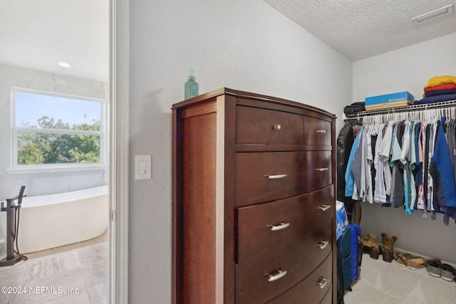 walk in closet featuring light tile patterned flooring