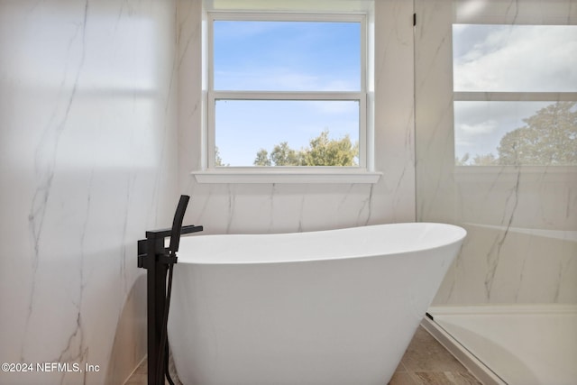 bathroom featuring a tub to relax in