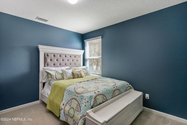 carpeted bedroom featuring a textured ceiling