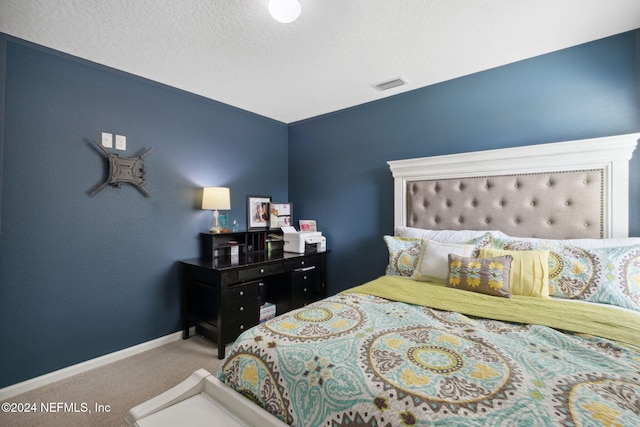 carpeted bedroom featuring a textured ceiling