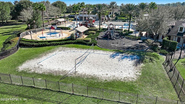 view of community with a lawn and volleyball court