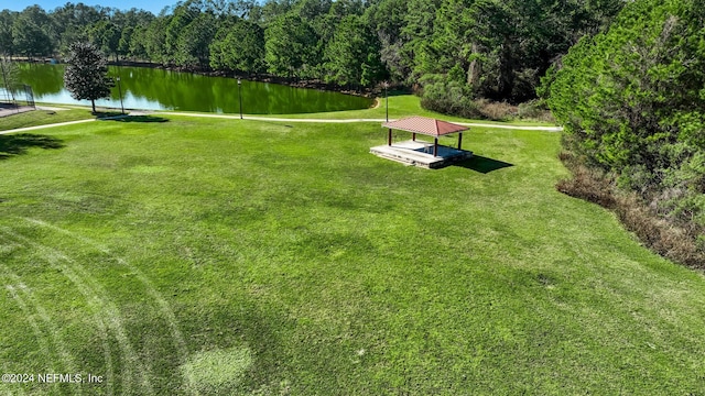 view of home's community featuring a yard and a water view