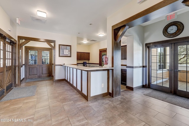 kitchen with kitchen peninsula and french doors