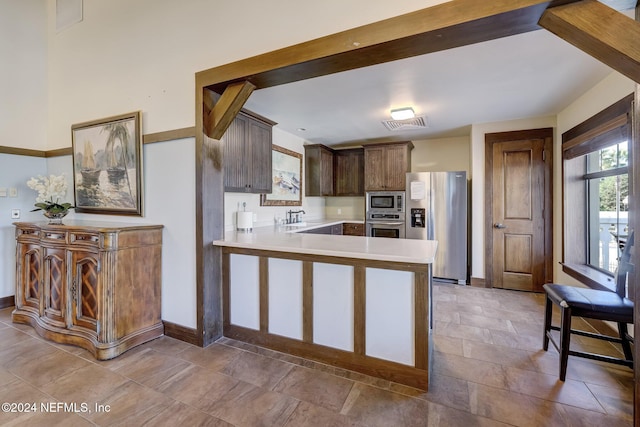 kitchen with kitchen peninsula, sink, and stainless steel appliances