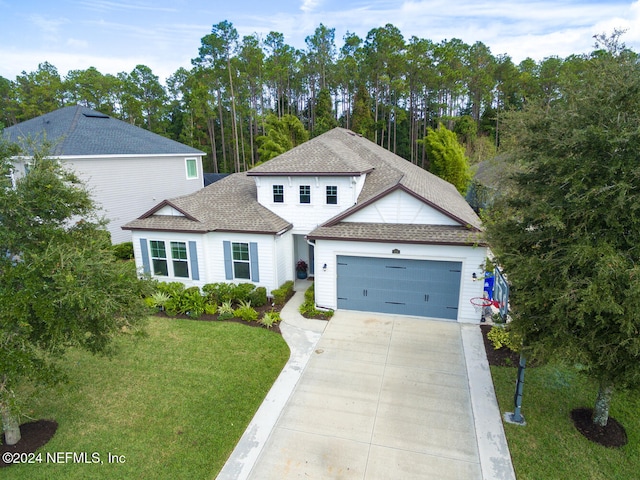 view of front of home featuring a garage and a front lawn