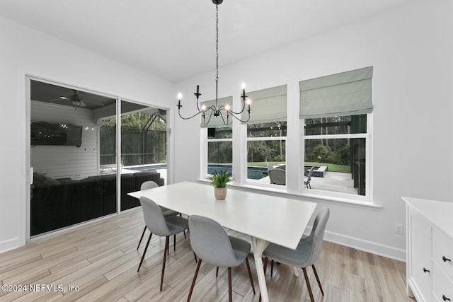 dining area with a notable chandelier and light wood-type flooring