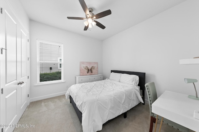 bedroom with ceiling fan and light colored carpet