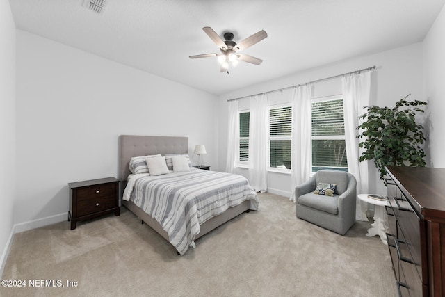 bedroom with ceiling fan and light colored carpet