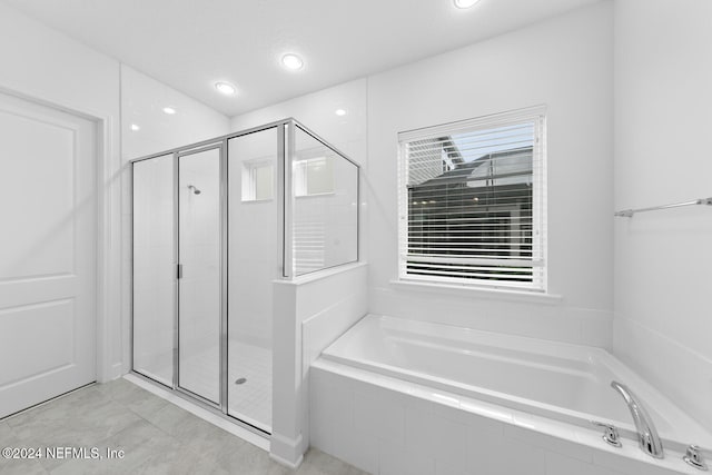 bathroom with tile patterned floors and plus walk in shower