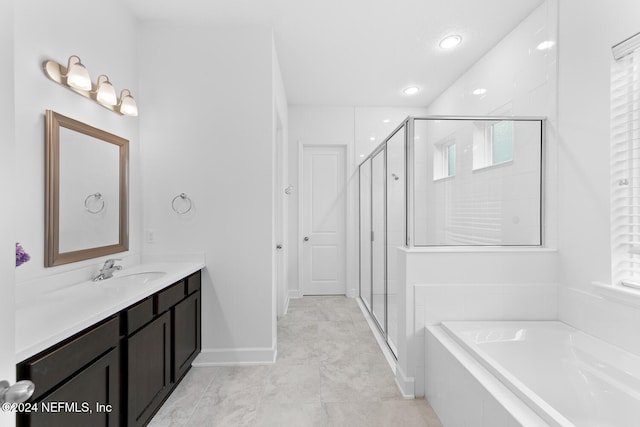 bathroom with plus walk in shower, vanity, and tile patterned floors