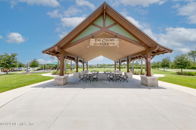 view of community with a patio area and a lawn