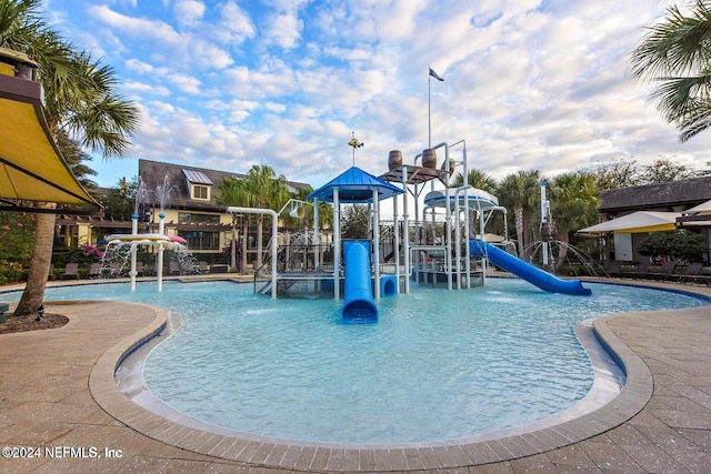 view of pool with a playground