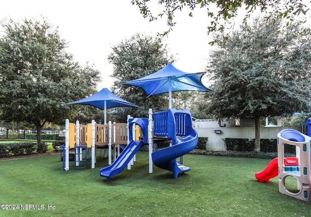 view of jungle gym with a lawn