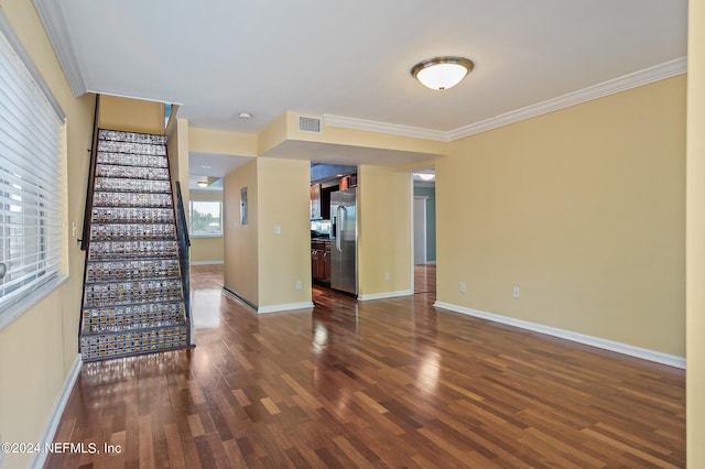 empty room with dark hardwood / wood-style flooring and ornamental molding