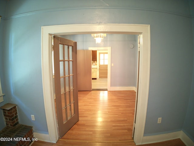 corridor with light hardwood / wood-style floors