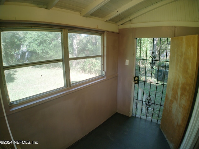 interior space with vaulted ceiling with beams, plenty of natural light, and wood ceiling