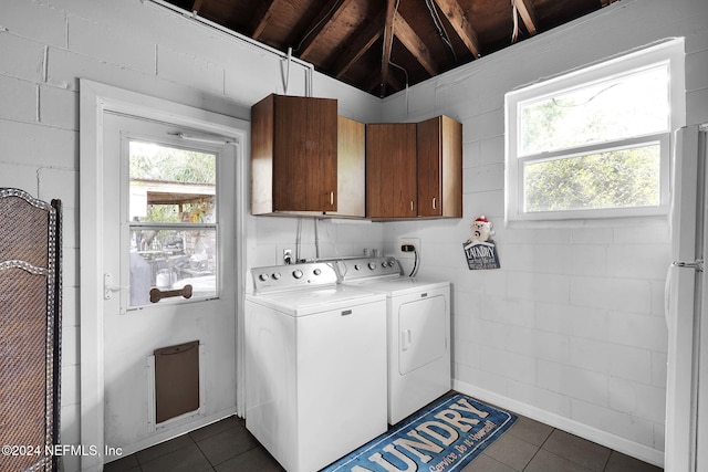 washroom featuring washer and dryer, cabinets, dark tile patterned flooring, and wooden ceiling