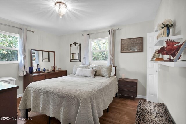 bedroom with dark hardwood / wood-style floors