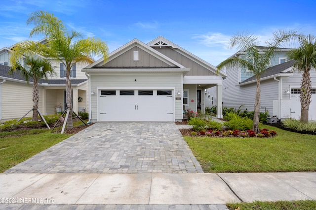 view of front of property with a garage and a front yard