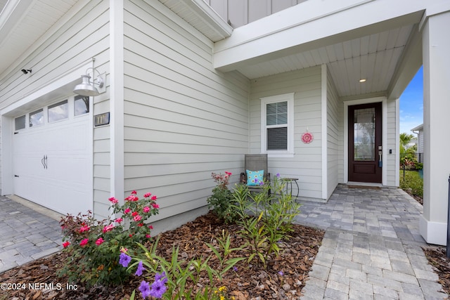 view of exterior entry with a garage